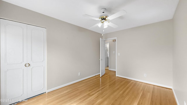 unfurnished bedroom with a ceiling fan, baseboards, and light wood finished floors