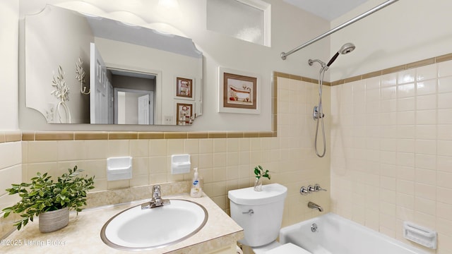 full bathroom with washtub / shower combination, toilet, tile walls, and vanity