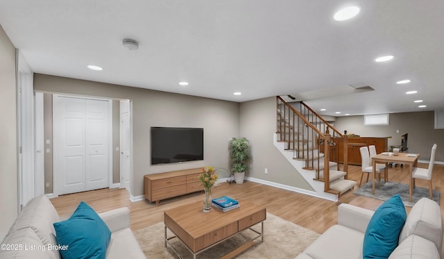 living room with recessed lighting, baseboards, stairs, and light wood finished floors