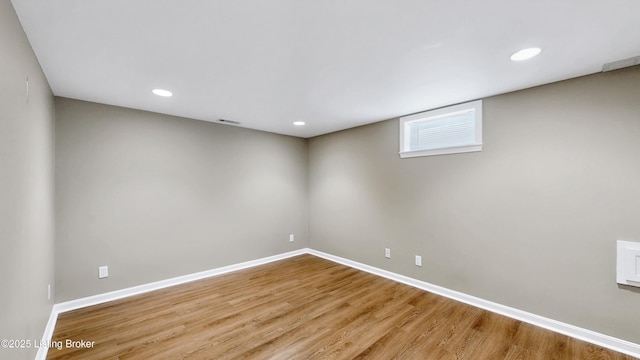 empty room with visible vents, baseboards, and wood finished floors