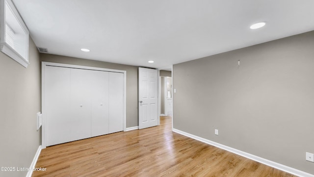 unfurnished bedroom featuring recessed lighting, light wood-type flooring, baseboards, and visible vents