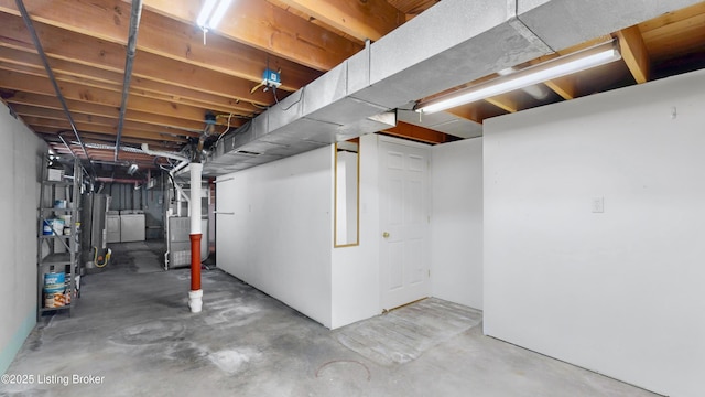 unfinished basement with independent washer and dryer