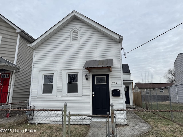 view of front facade with a fenced front yard and metal roof