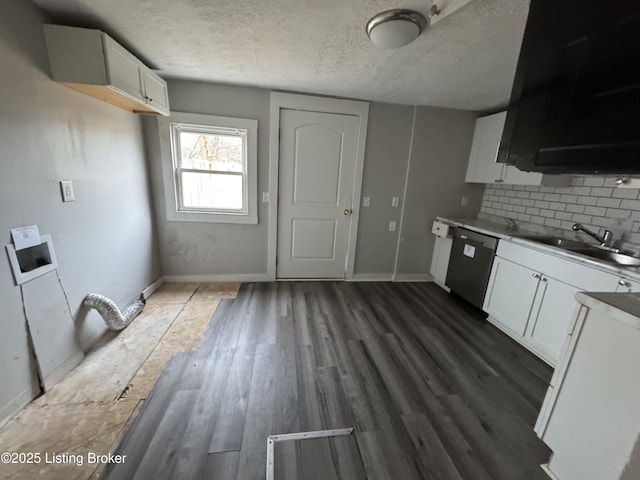 kitchen featuring a sink, backsplash, a textured ceiling, dark wood-style floors, and dishwasher