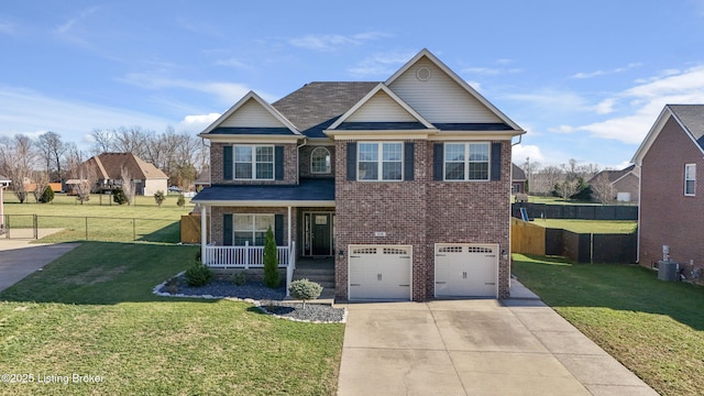 craftsman house featuring fence, driveway, covered porch, a front lawn, and brick siding