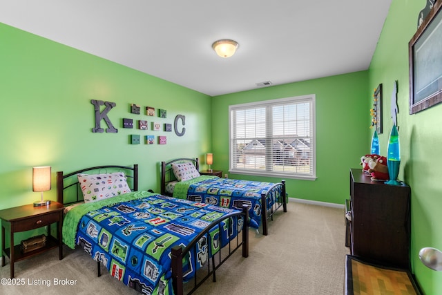 carpeted bedroom featuring visible vents and baseboards