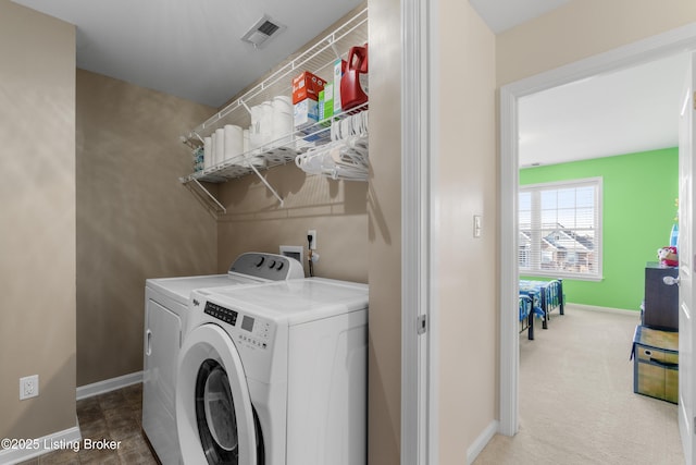 laundry room with laundry area, baseboards, visible vents, and washer and clothes dryer