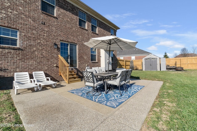 view of patio with entry steps, an outdoor structure, a storage unit, and fence