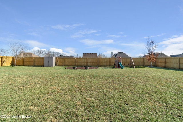 view of yard featuring a fenced backyard and a playground