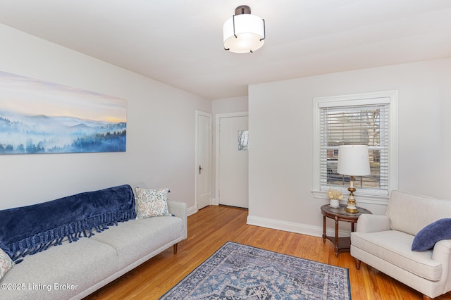 living area featuring baseboards and wood finished floors