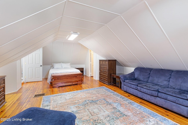 bedroom featuring visible vents, vaulted ceiling, and hardwood / wood-style flooring