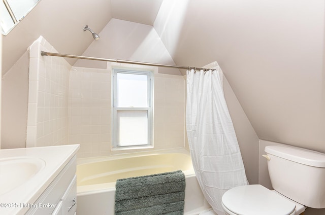 bathroom featuring vanity, vaulted ceiling, shower / bath combination with curtain, and toilet