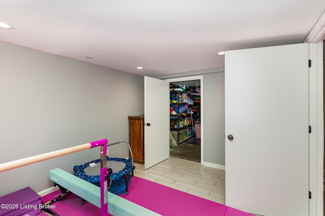 exercise room featuring recessed lighting and light tile patterned flooring