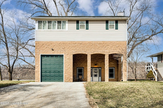 view of front facade with a front lawn, concrete driveway, and an attached garage