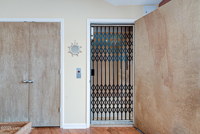 room details featuring baseboards and wood finished floors