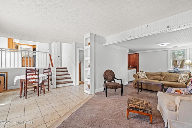 living room featuring light tile patterned floors, stairway, light carpet, and a textured ceiling