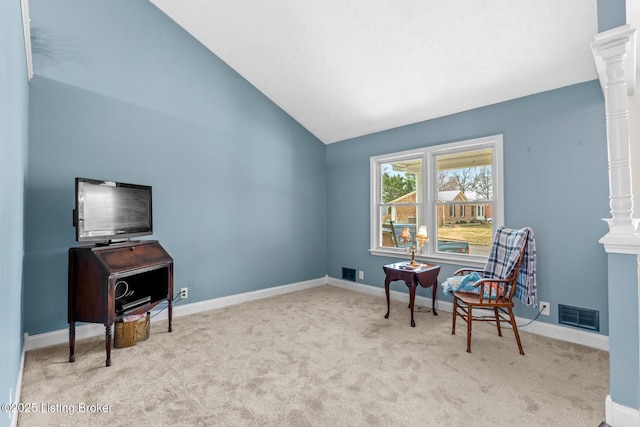 sitting room featuring vaulted ceiling, carpet flooring, baseboards, and visible vents