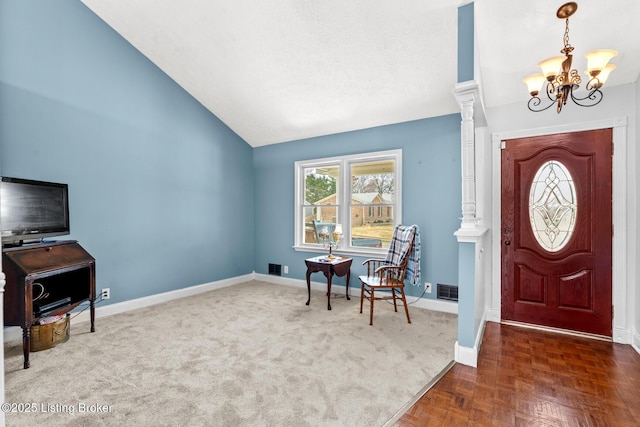 foyer featuring visible vents, baseboards, lofted ceiling, a textured ceiling, and a chandelier