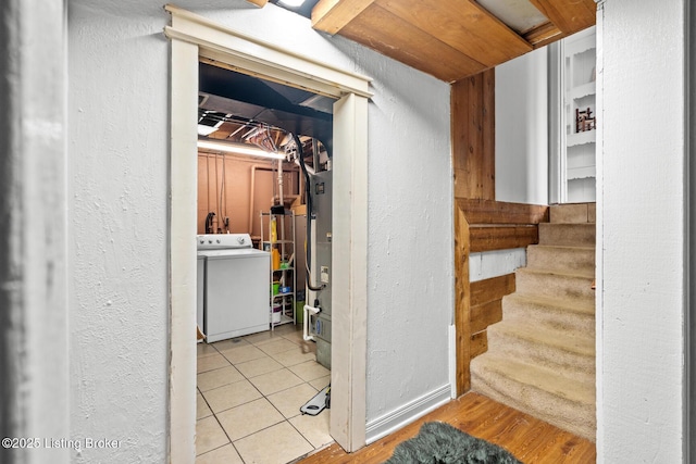 interior space featuring washer / dryer, stairway, and a textured wall