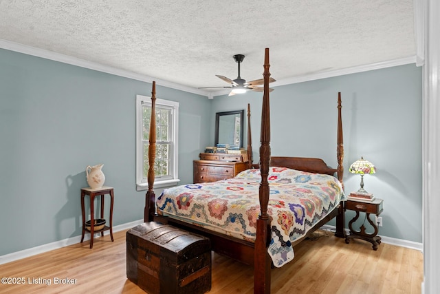 bedroom featuring light wood-style flooring, baseboards, and ornamental molding