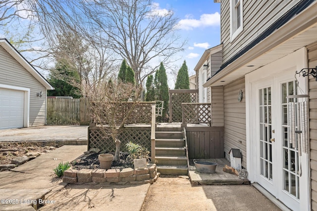 view of patio / terrace with french doors, a deck, and fence