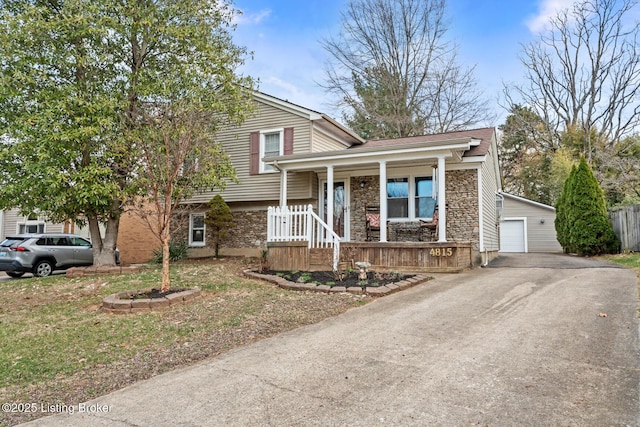 split level home with a porch, stone siding, and an outdoor structure