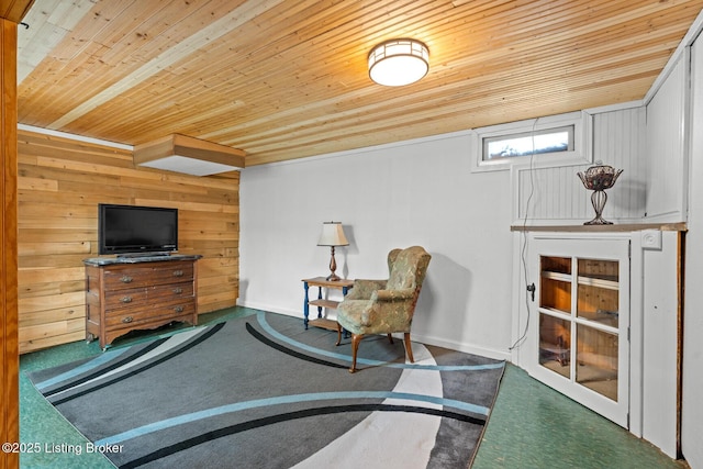 living area featuring wooden walls, wood ceiling, and carpet floors