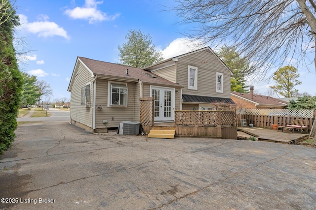 back of house featuring french doors, central air condition unit, and a deck