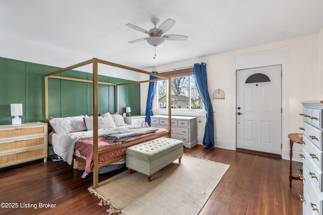 bedroom with baseboards, hardwood / wood-style floors, and a ceiling fan