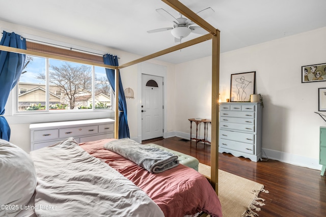 bedroom with visible vents, baseboards, wood finished floors, and a ceiling fan