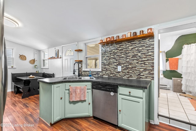 kitchen featuring a sink, backsplash, dark wood-style floors, green cabinetry, and dishwasher