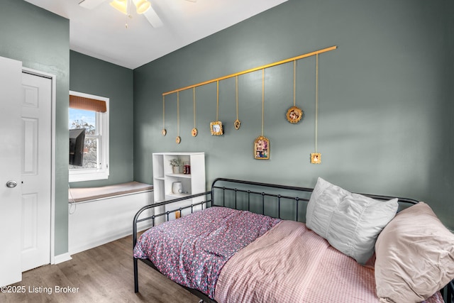 bedroom featuring wood finished floors and ceiling fan