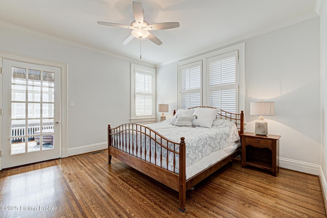 bedroom with baseboards, wood finished floors, and crown molding