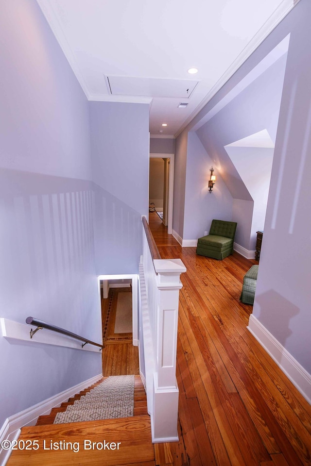 stairs featuring hardwood / wood-style floors, recessed lighting, baseboards, and ornamental molding