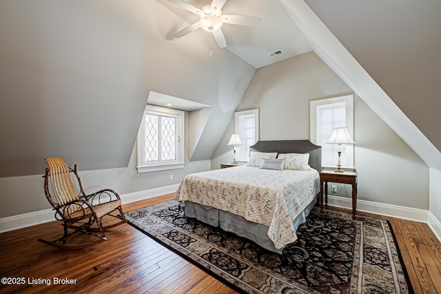 bedroom with hardwood / wood-style floors, a ceiling fan, baseboards, visible vents, and vaulted ceiling