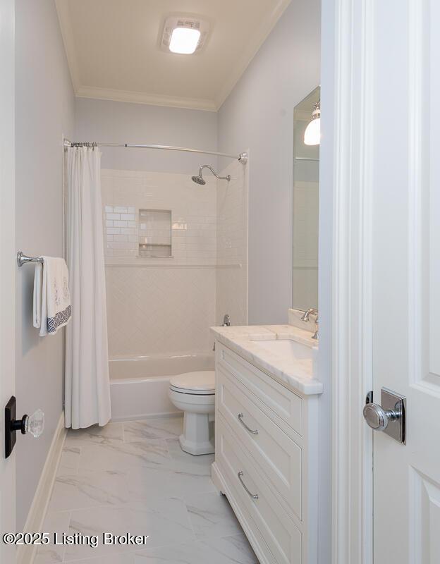 full bathroom featuring crown molding, toilet, shower / tub combo, marble finish floor, and vanity