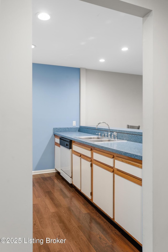 kitchen with recessed lighting, white dishwasher, dark wood-style flooring, and a sink