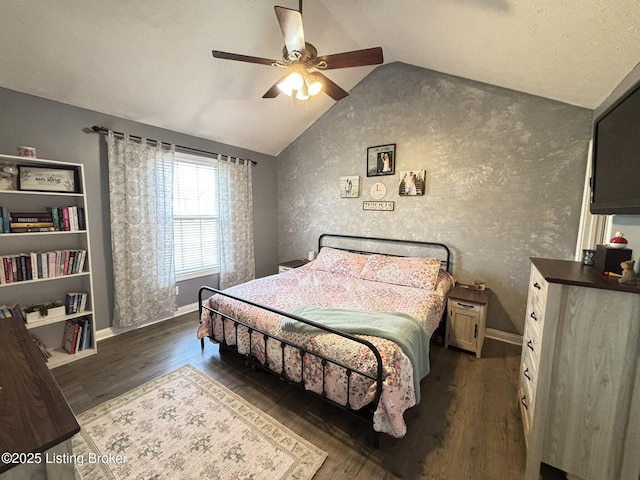 bedroom with ceiling fan, baseboards, dark wood-type flooring, and lofted ceiling