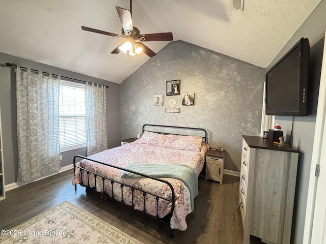 bedroom featuring a textured ceiling, dark wood-style floors, baseboards, ceiling fan, and vaulted ceiling