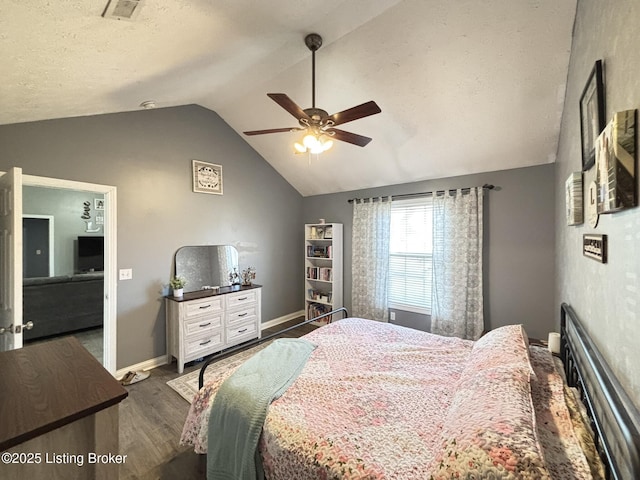 bedroom with visible vents, baseboards, dark wood-style flooring, and vaulted ceiling