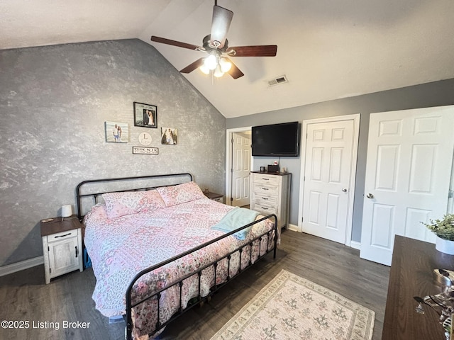 bedroom featuring visible vents, baseboards, lofted ceiling, and dark wood-style flooring