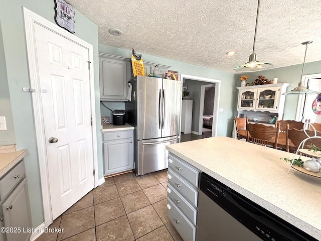 kitchen featuring stainless steel appliances, gray cabinetry, and light countertops