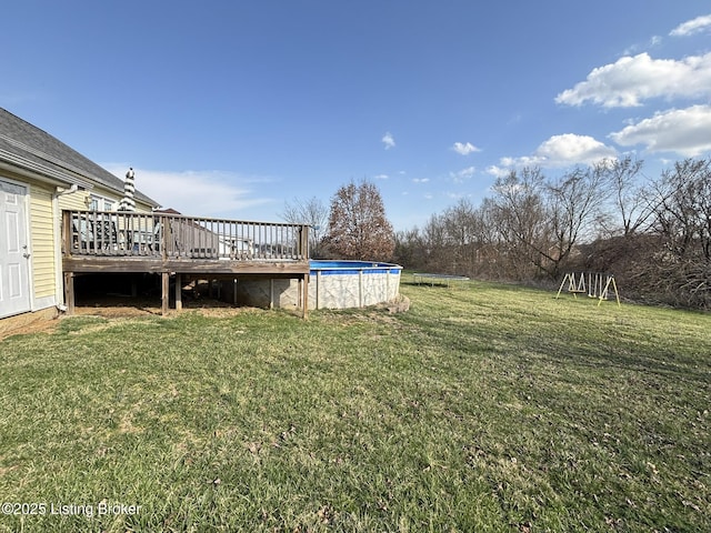 view of yard with an outdoor pool and a deck