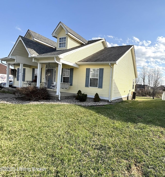 view of front of property featuring a porch, roof with shingles, central AC unit, and a front yard