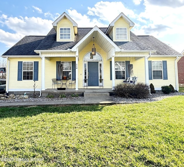 cape cod-style house featuring a front lawn, a porch, and a shingled roof