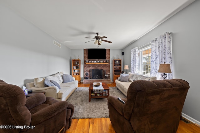 1380 Rice Rd, Lawrenceburg, KY 40342 - living room featuring a fireplace, light wood-style floors, a ceiling fan, and visible vents