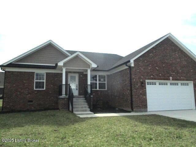 view of front of home with a front yard, brick siding, a garage, and driveway