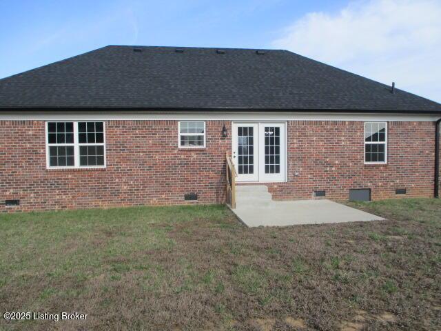 rear view of house with a patio, a yard, roof with shingles, crawl space, and brick siding