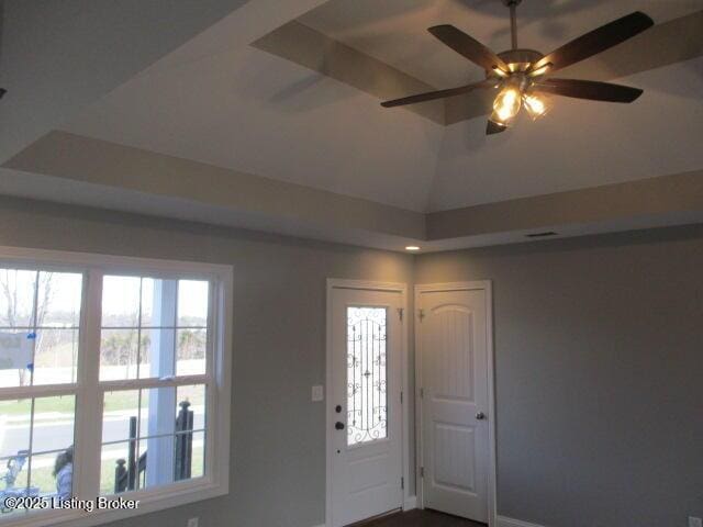 foyer entrance featuring vaulted ceiling and a ceiling fan