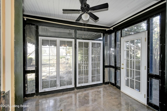 unfurnished sunroom with ceiling fan